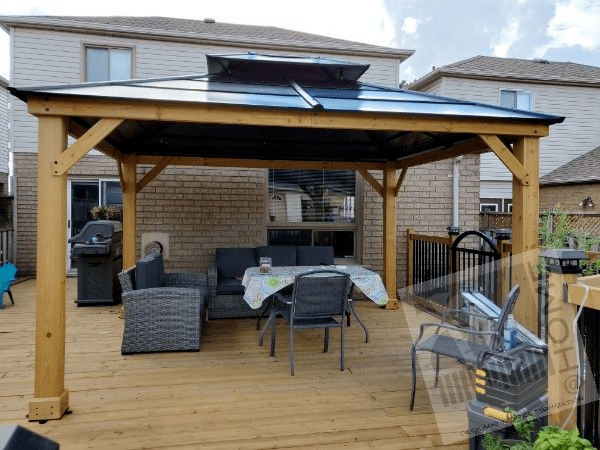 Wooden Gazebo on wooden deck with metal fence