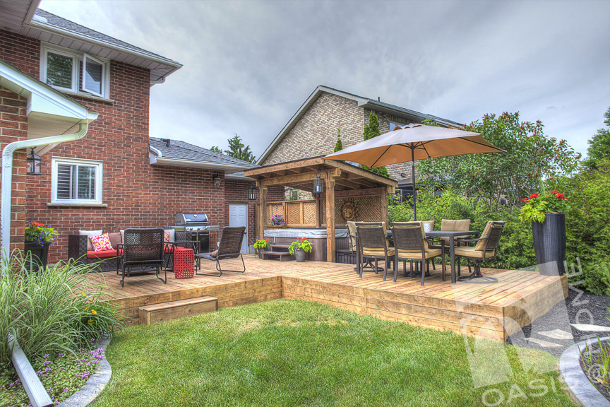 Shaded hot tub on top of a wooden deck