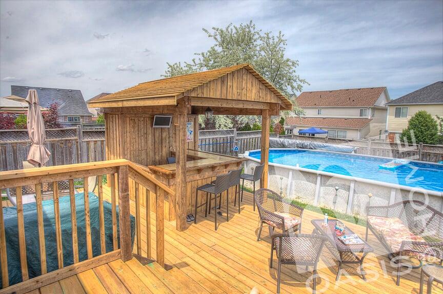 Custom Bar with a wooden fence and a pool
