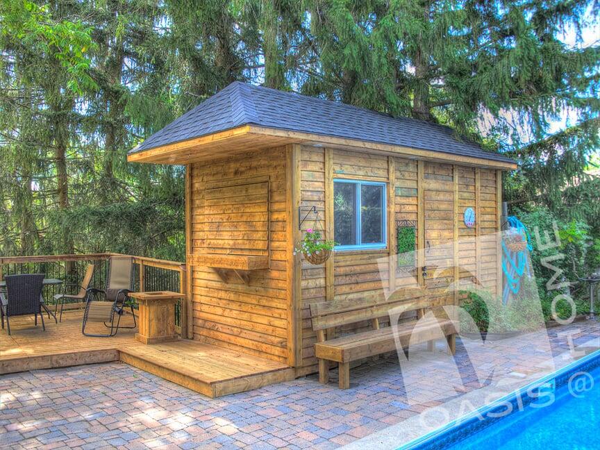 Wooden poolhouse with a fence